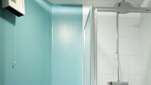 A bathroom with a toilet, a shower, and a wall-mounted air purifier. - The Maple Hotel (Liverpool)