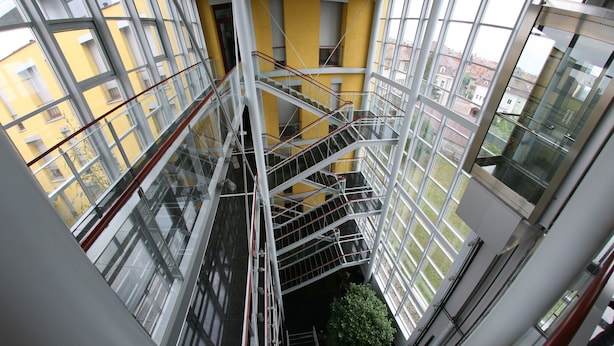 A multi-level interior with glass railings and a central staircase. - Hotel Savoy (Timisoara)