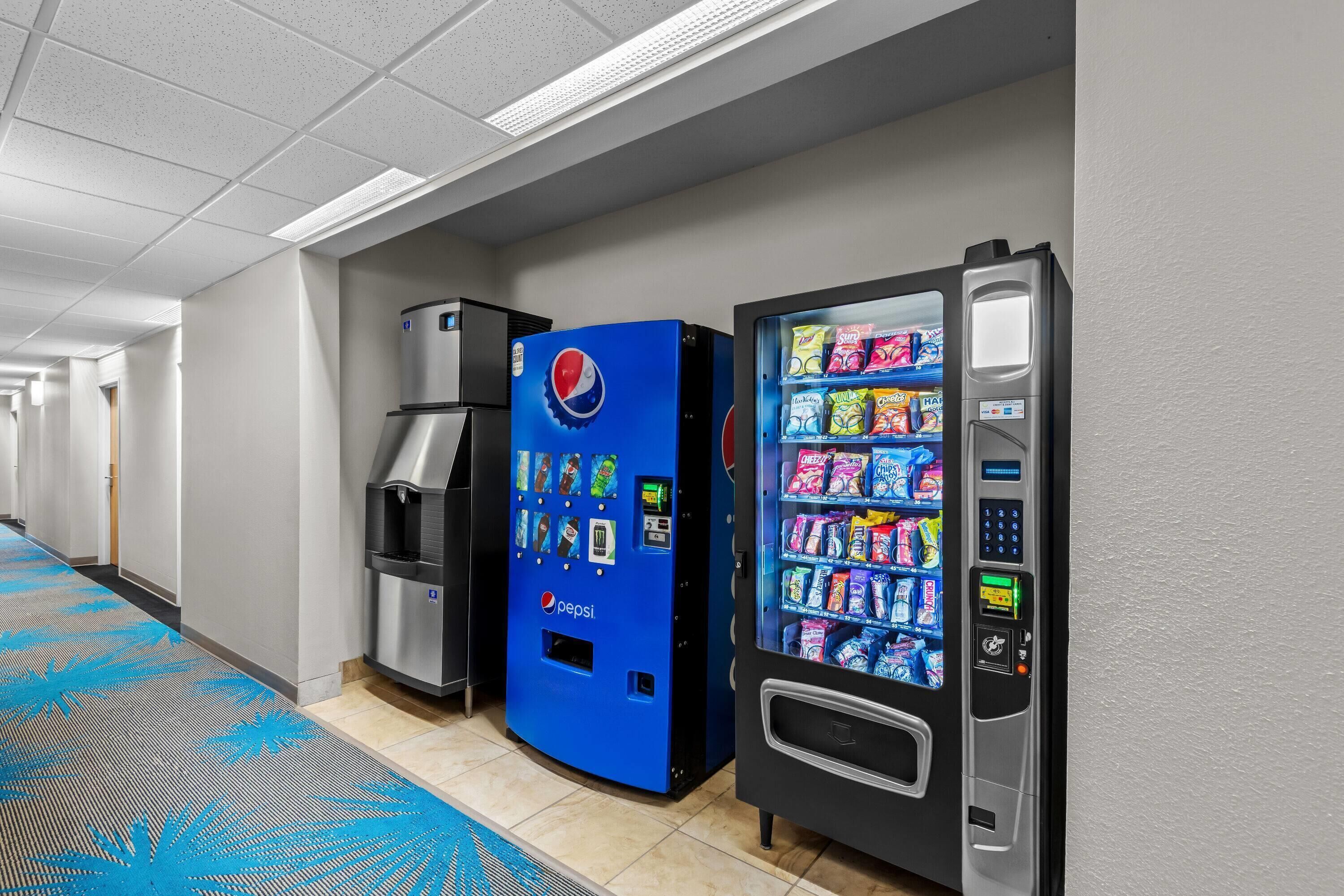 A hallway with vending machines, including a Pepsi cooler and a snack vending machine.