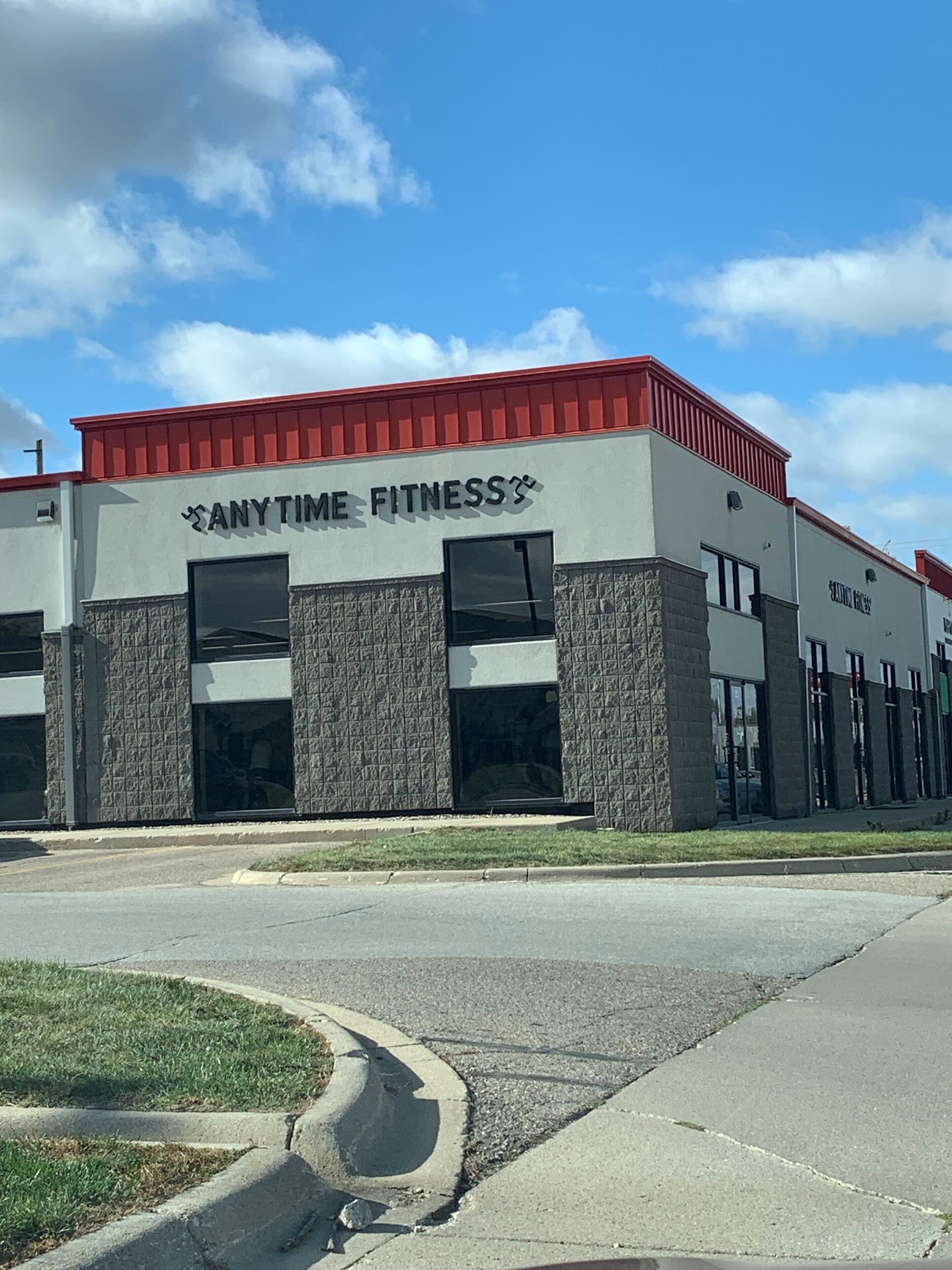 A building with the sign "Anytime Fitness" on the facade.