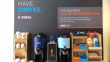 A coffee station with E. Press coffee machines and a sign promoting IHG Rewards Club.