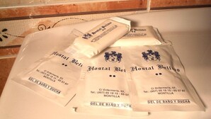 Four packages labeled 'Hostal Bellido' with contact information and 'Gel de Bano y Duch' text. - Bellido (Montilla)