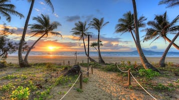 On the beach, white sand, sun-loungers, beach umbrellas