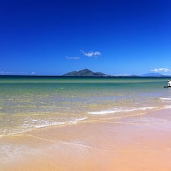 En la playa, playa de arena blanca, camastros y sombrillas