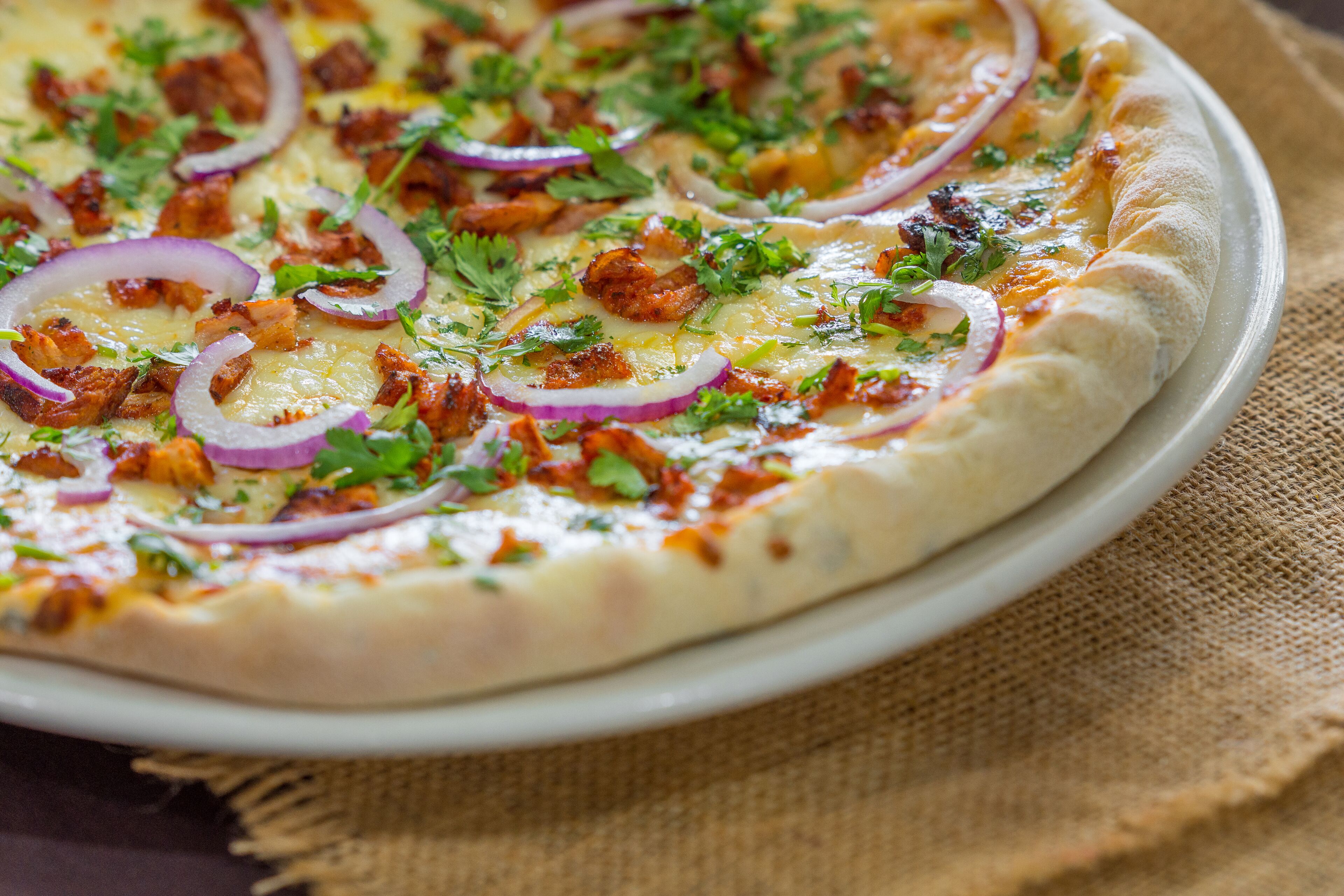 A pizza with toppings on a plate.