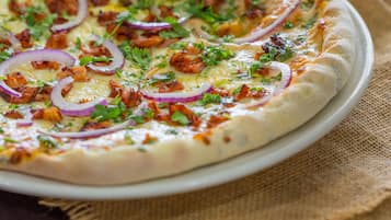 A pizza with toppings on a plate.
