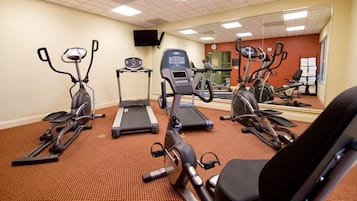 A gym with treadmills, elliptical machines, and stationary bikes.