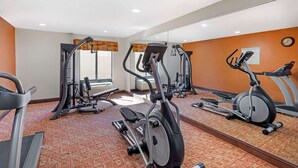 A gym with various exercise equipment, including treadmills and elliptical machines. - Quality Inn Raleigh Downtown (Raleigh)