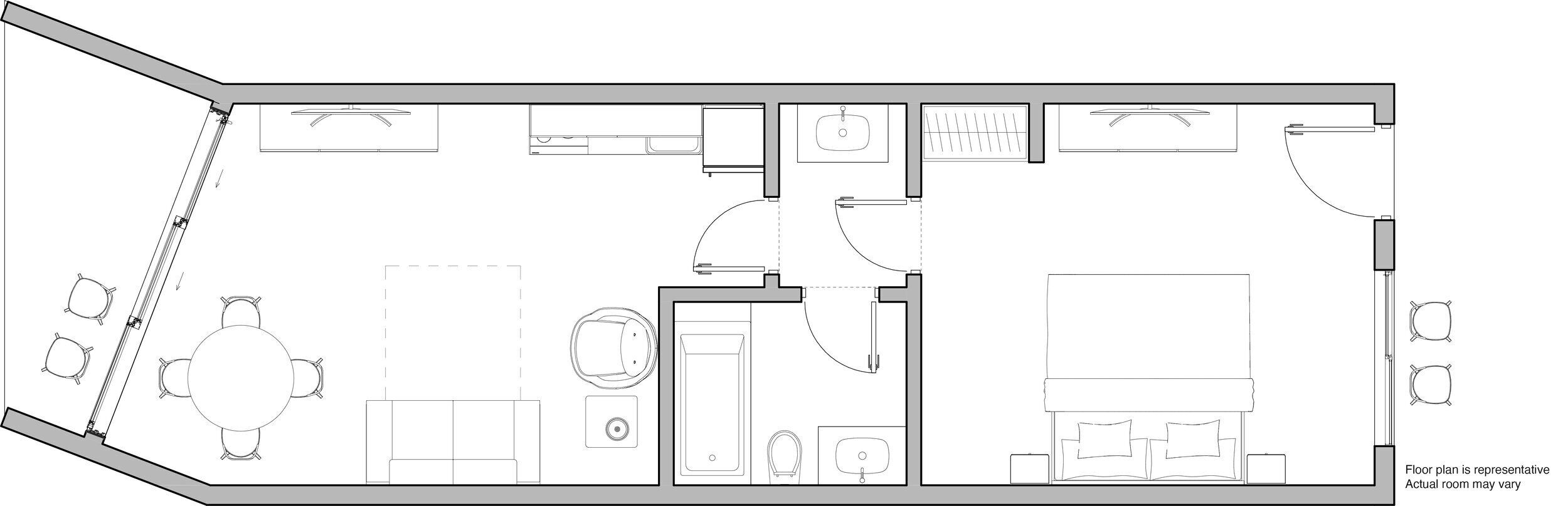 Plano de planta de una habitación de hotel que incluye una cama, un escritorio, una silla, un baño pequeño y una zona de estar.
