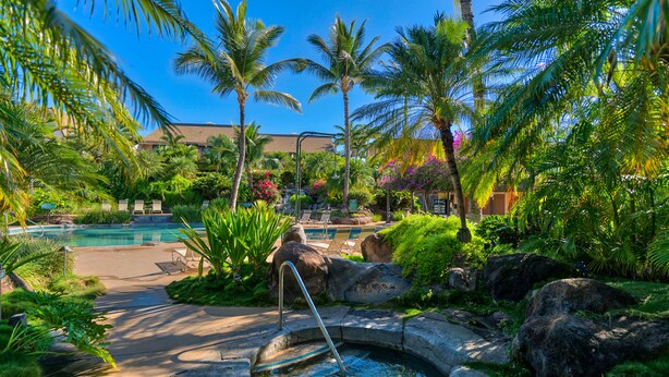 A resort with a swimming pool, lounge chairs, and tropical landscaping. - Maui Kamaole (Kihei)