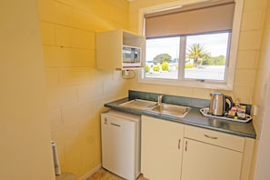 Family Studio, Multiple Beds | Private kitchen | Fridge, microwave, stovetop, electric kettle