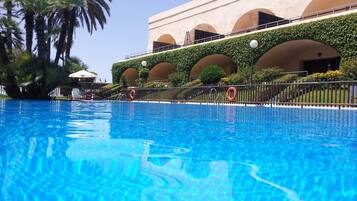 Outdoor pool, open noon to 8:00 PM, pool umbrellas, pool loungers