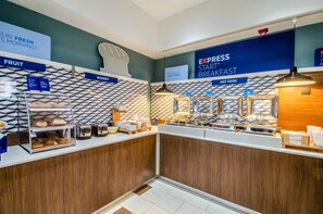 A breakfast bar with labeled sections for fruit, bakery, and hot food. - Holiday Inn Express & Suites Olathe South by IHG (Olathe)