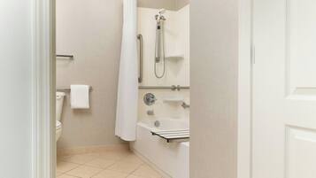 A bathroom with a toilet, a shower, and a bathtub.