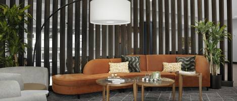 Un salon moderne avec un canapé aux lignes courbes, deux tables d’appoint et un grand lampadaire.