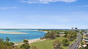 A coastal cityscape with a clear view of a bay, buildings, and a road. - Space Holiday Apartments (Maroochydore)