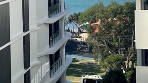 A multi-story hotel with balconies overlooking a beach. - Space Holiday Apartments (Maroochydore)