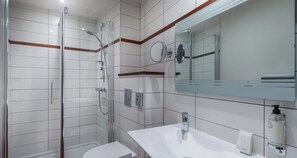 A modern bathroom with a glass-enclosed shower, a white sink, and a mirror above the sink. - Best Western Le Duguesclin (Saint-Brieuc)