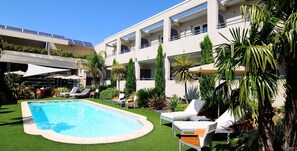 Outdoor pool, open 9 AM to 8 PM, pool umbrellas, pool loungers