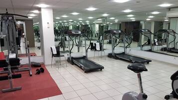 A gym with treadmills, a stationary bike, and weight machines.