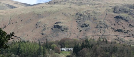 A house with a view of a lake and mountains.