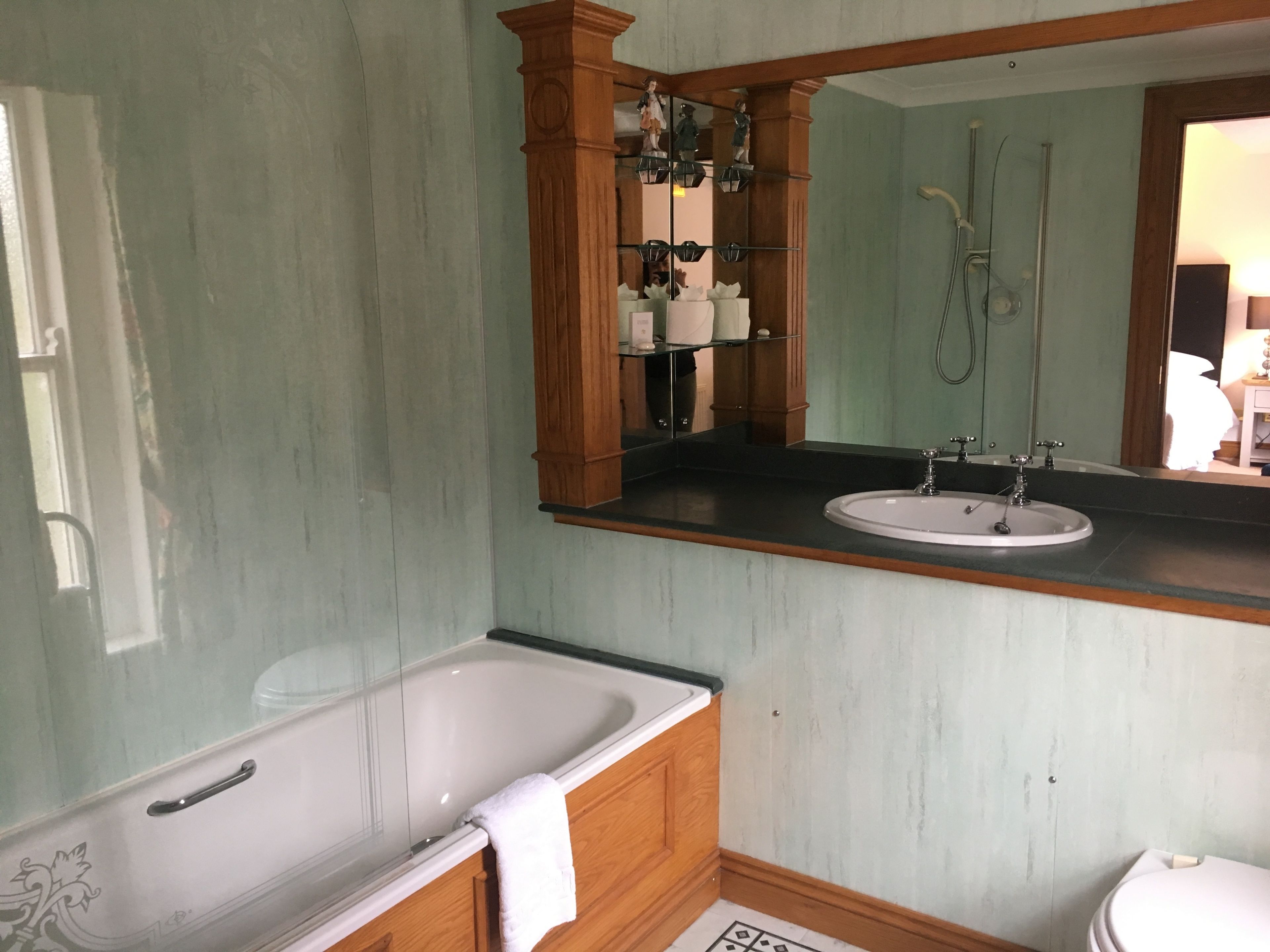 A bathroom with a bathtub, sink, and toilet.