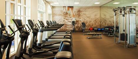 A gym with treadmills, exercise balls, and weight machines.