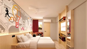 A modern hotel room with a large bed, a desk, and a wardrobe. - Ginger Bangalore Whitefield (Bengaluru)