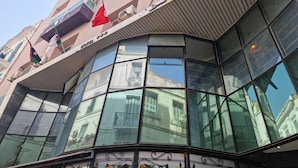 A modern building with large glass windows and balconies. - Tunisie Confort (Tunis)