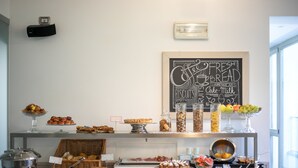 A buffet with various food items and a chalkboard sign advertising fresh bread and homemade jam. - DA ELDA natural retreat (Ledro)
