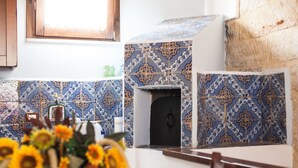 A kitchen with patterned tiles, a window, and a vase of sunflowers on the table. - Cinisi Vacanze (Cinisi)