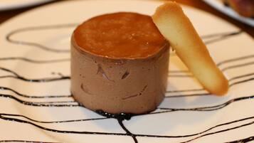 A dessert with chocolate sauce and a wafer stick on a plate.