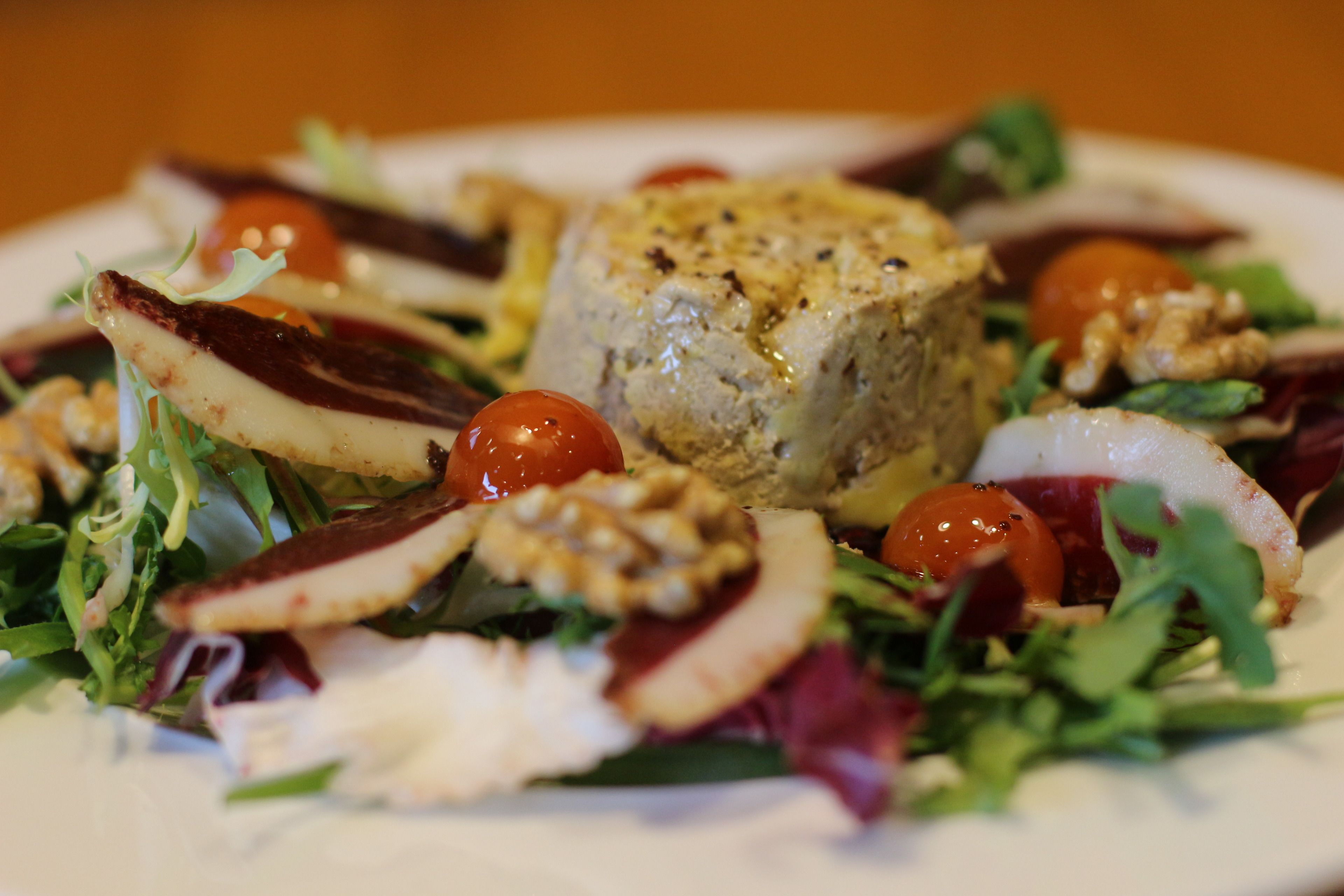 A plate of food with a variety of vegetables and a central piece of food.