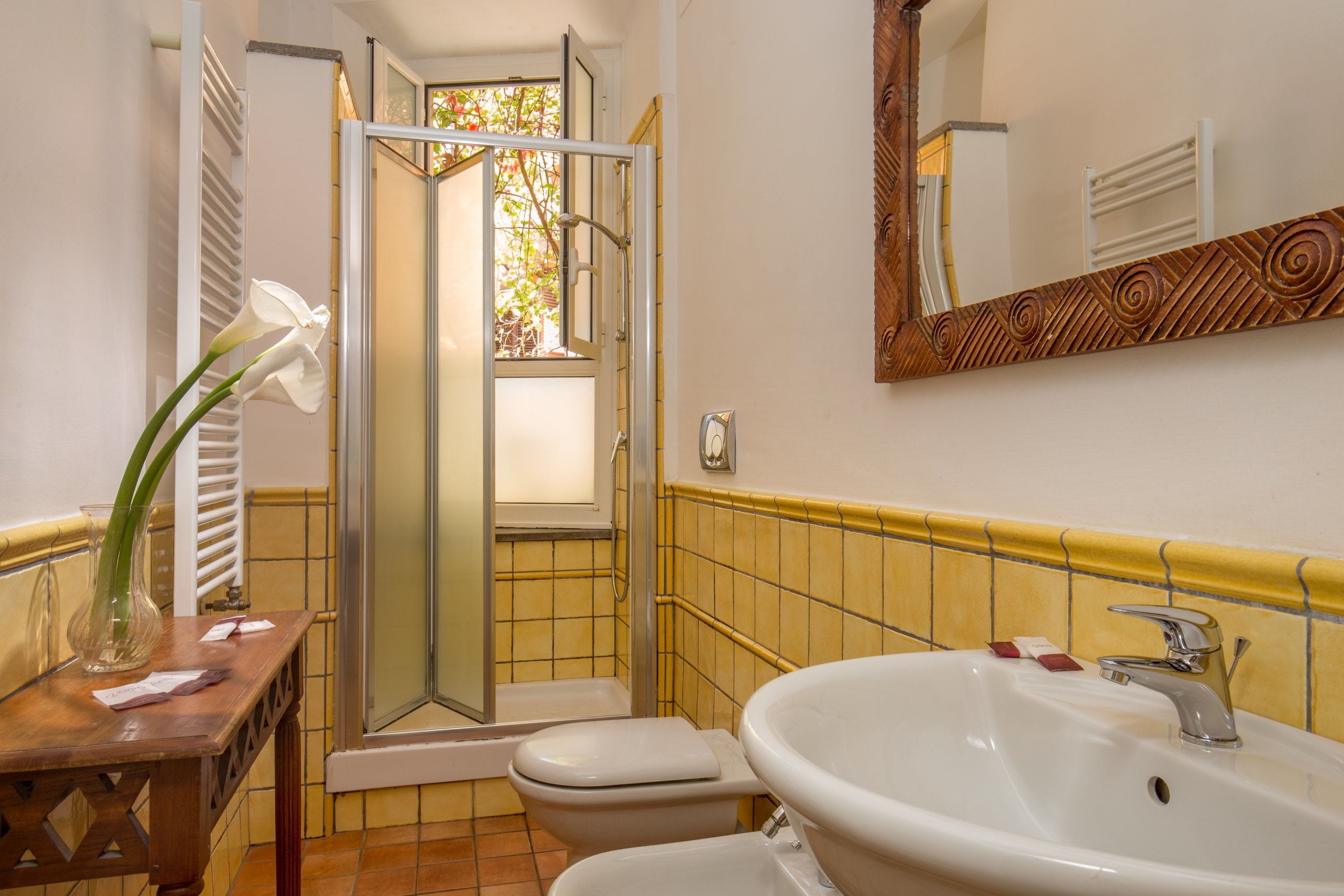 A bathroom with a white sink, a toilet, and a shower with a glass door.
