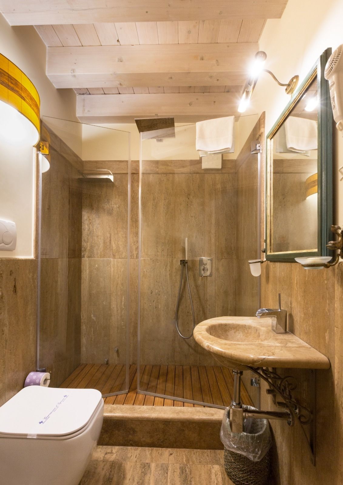 A bathroom with a shower, a sink, and a toilet.