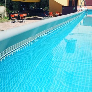 Seasonal outdoor pool, pool umbrellas, pool loungers