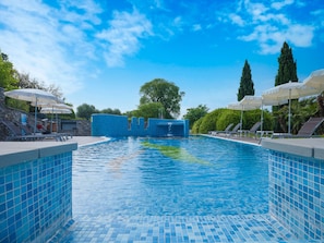 Indoor pool, seasonal outdoor pool, pool umbrellas, pool loungers