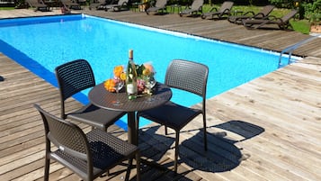 Alberca al aire libre y camastros