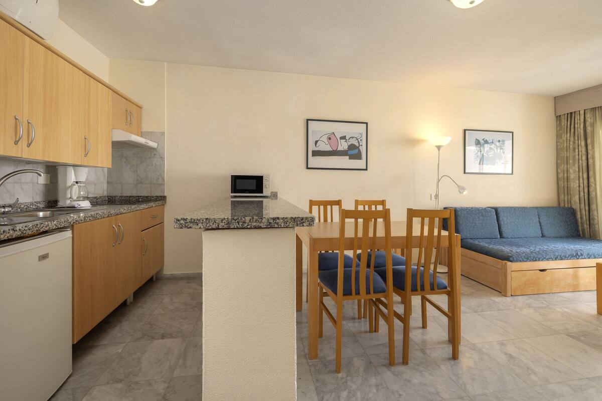 A compact living space with a kitchen, dining area, and seating area.