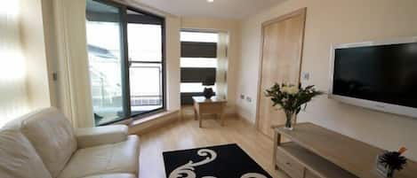 Deluxe Apartment, 2 Bedrooms | Living area | 40-inch flat-screen TV with satellite channels, TV, DVD player