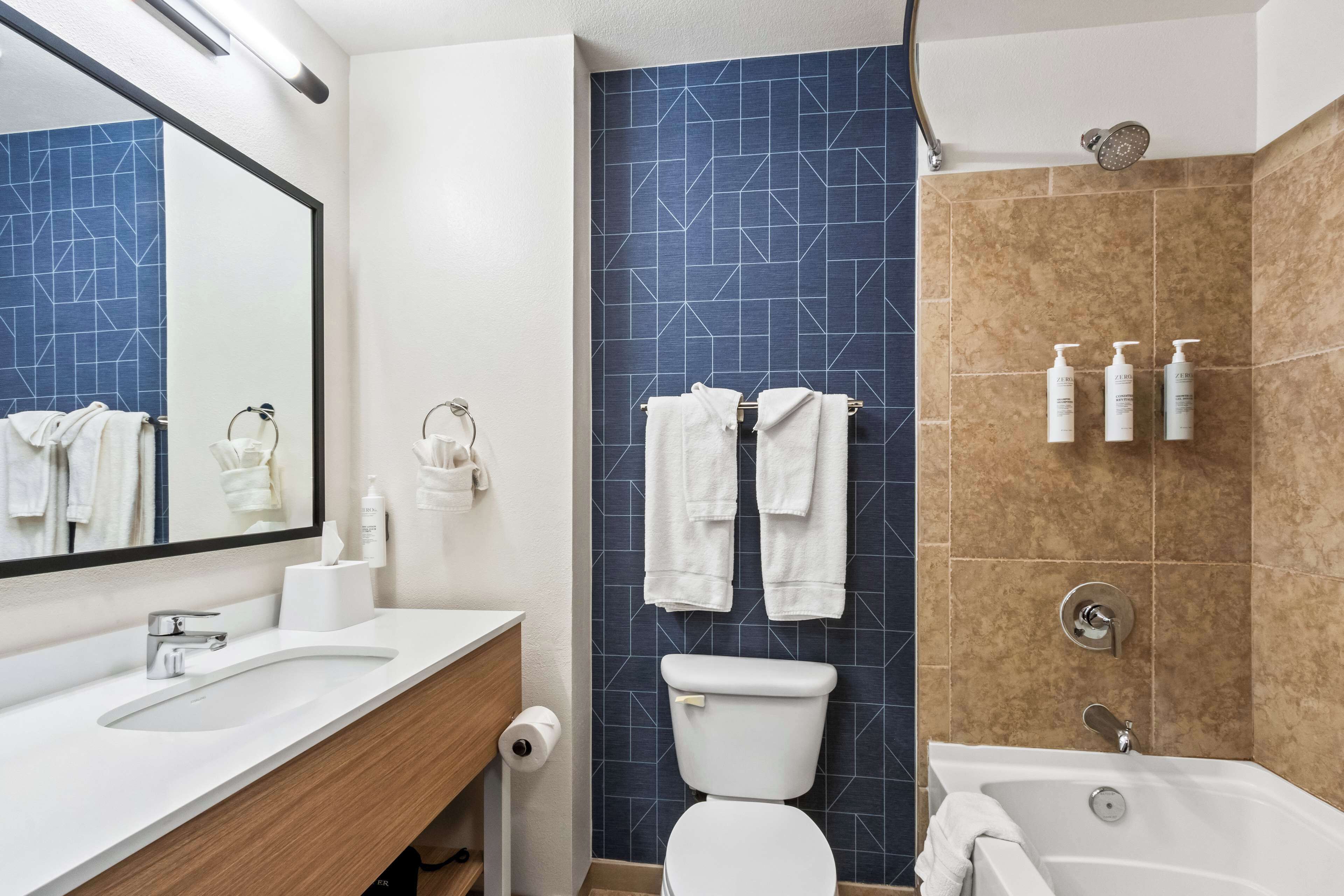 room, 2 queen beds | bathroom | combined shower/bathtub, free toiletries, hair dryer, towels