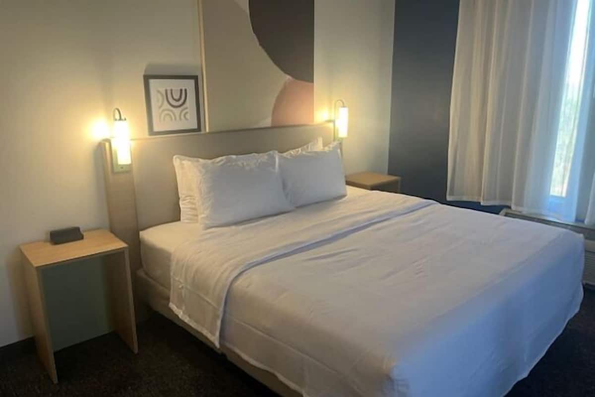 premium bedding, laptop workspace, blackout curtains, iron/ironing board