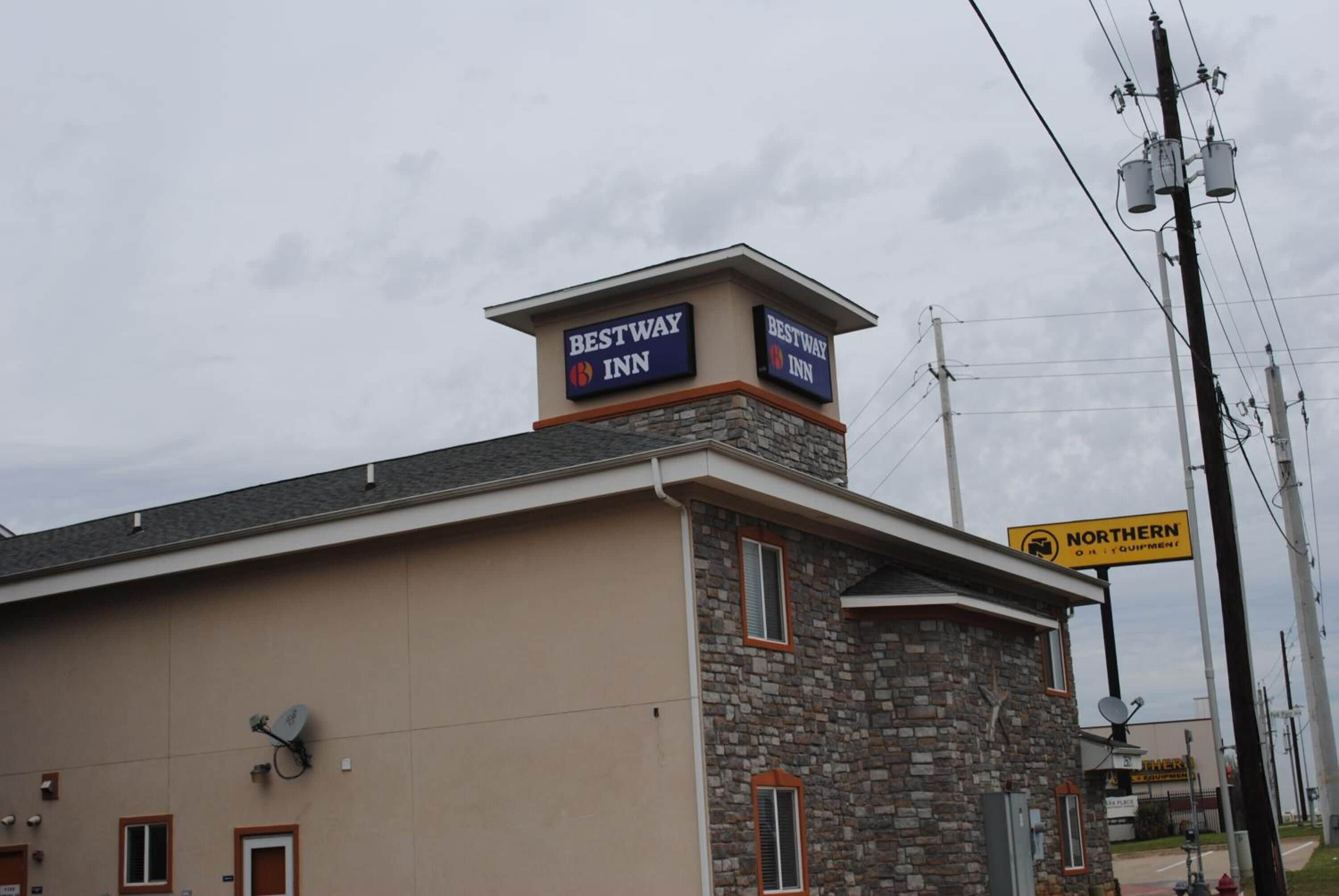 A Bestway Inn building with a stone facade and a sign indicating Northern Equipment.