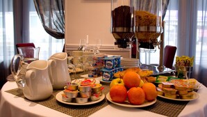 A breakfast buffet with various food items and beverages. - Majestic (Lourdes)