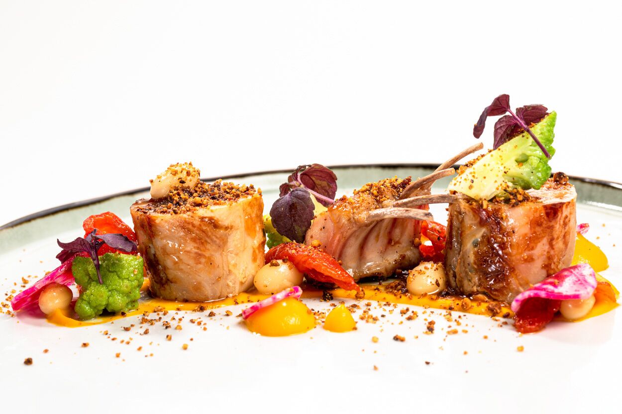 A plated dish with various food items and garnishes.
