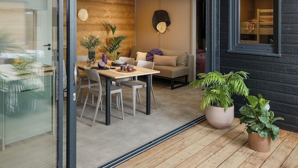 A modern interior with a dining area, a sofa, and potted plants. - VVF Aubrac, Chaudes-Aigues (Chaudes-Aigues)