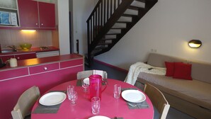 A compact living space with a kitchen, dining area, and a staircase. - VVF Queyras, Ceillac-en-Queyras (Ceillac)