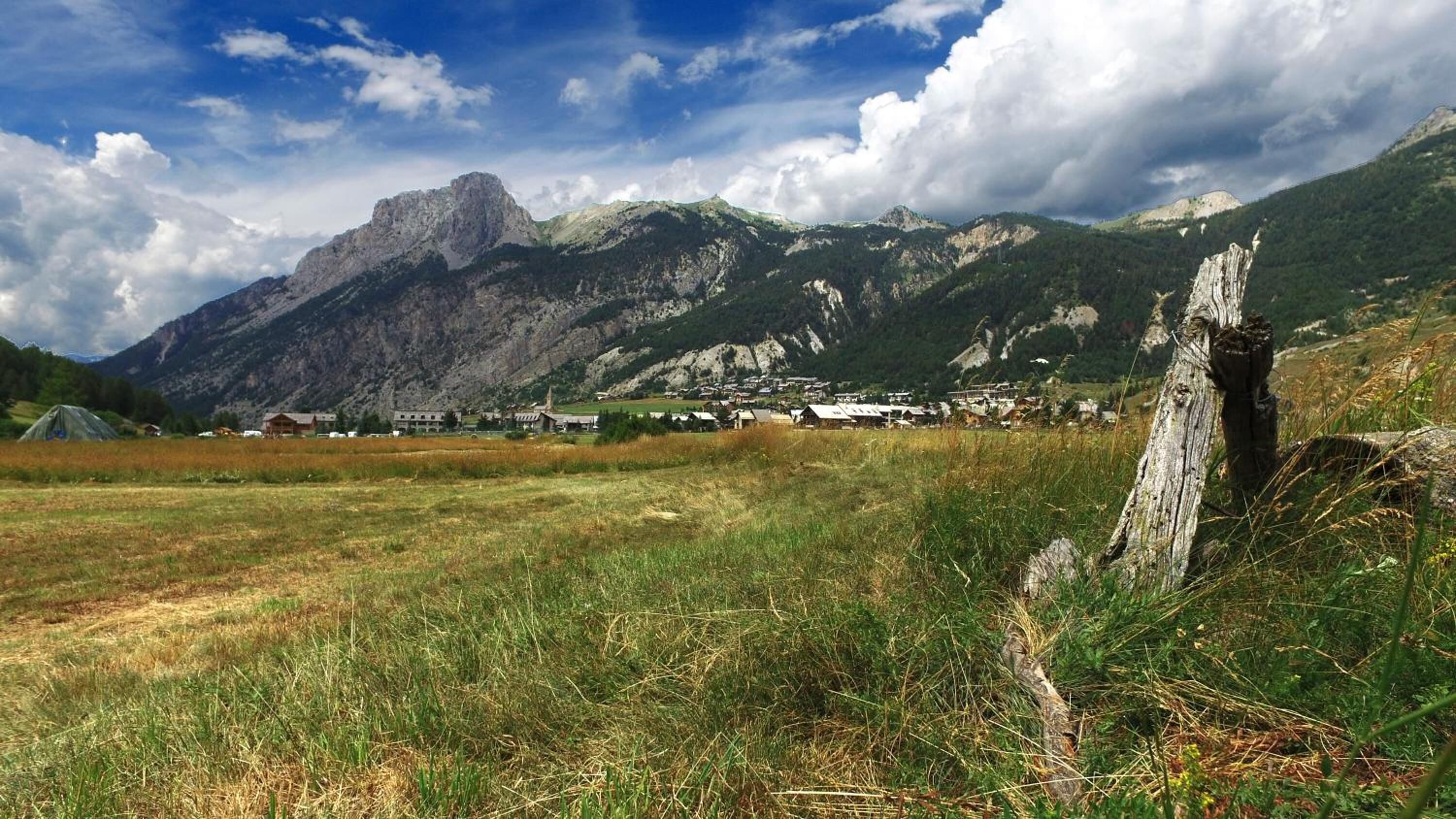 A mountainous landscape with a village nestled among the hills.