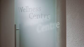 A frosted glass door with the words "Wellness Centre" etched on it.
