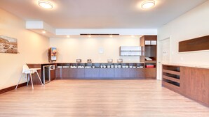 A modern kitchen with a central island, built-in appliances, and a seating area.
